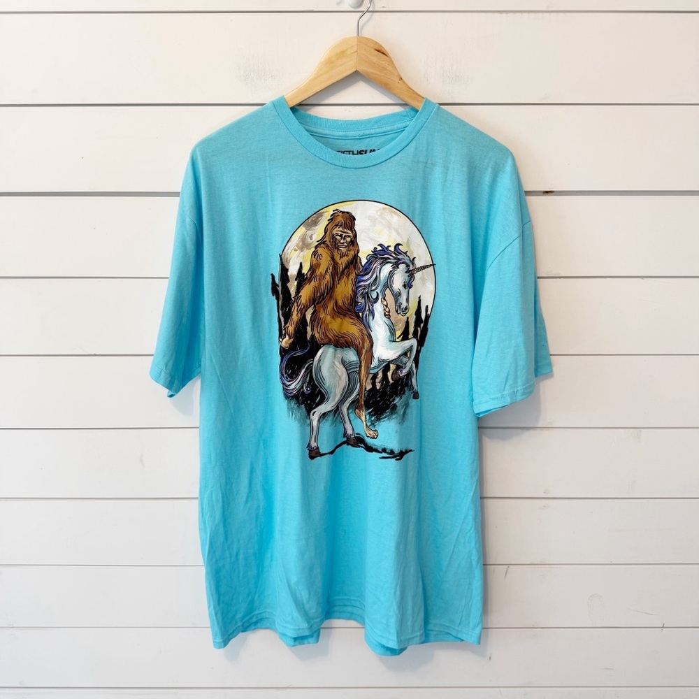 Fifth-Sun | Men’s Blue Bigfoot Riding Unicorn  100% Cotton T-Shirt Size 2XL